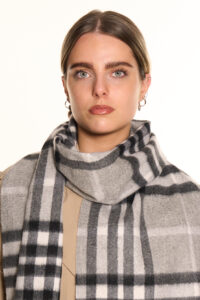 A grey cashmere scarf elegantly folded in a signature box.
